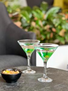 two martini glasses and a bowl of food on a table at Hotel Puerto Palace in Puerto de la Cruz