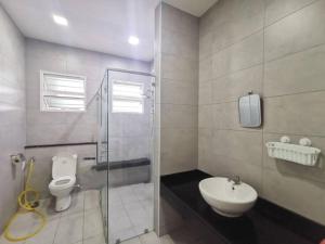 a bathroom with a shower and a toilet and a sink at Bandar Seri botani Ipoh luxury paris/17 pax/mahjong in Ipoh