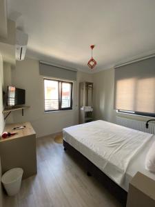 a bedroom with a large white bed and two windows at Vera Edirne in Edirne