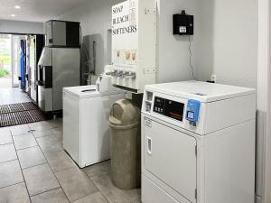 a room with white appliances in a room at Suites Lafayette IN in Lafayette