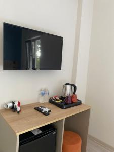 a tv on a wall above a table with a tea kettle at Vera Edirne in Edirne