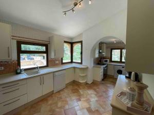 a large kitchen with white cabinets and a tile floor at Casa Estrella in El Dondo