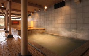 a room with a pool of water in a building at Aishinkan in Morioka