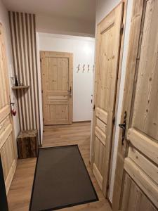 a hallway with two doors and a mat on the floor at Mont Blanc 25, vue Mont blanc, balcon, parking in Chamonix