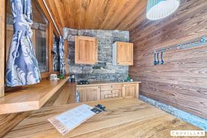 a kitchen with wooden cabinets and a counter in a room at Stone in Murter +18 photos