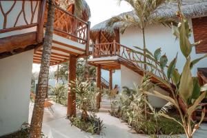 a resort with a staircase and palm trees at AmarBacalar in Bacalar