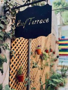 a sign that reads not terrace hanging on a wall with potted plants at Zaman Ya Zaman Boutique Hotel in Amman