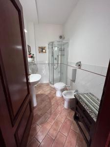 a bathroom with a shower and a toilet and a sink at Tenuta Poggio alla Farnia in Fauglia +71 photos