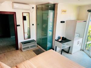 a bedroom with a glass shower and a bed at Bed Station 210 in Kandy