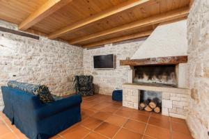 a living room with a blue couch and a fireplace at Pilato in Vižinada