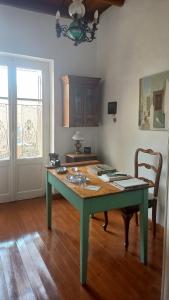 a green table in a room with a wooden floor at Katoi in Kothréas