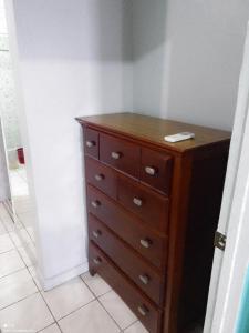 a wooden dresser in a corner of a room at The Couples Inn in Montego Bay