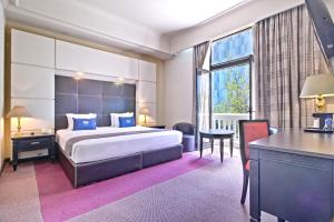 a hotel room with a large bed and a desk at Hotel Imperial Reforma in Mexico City +103 photos