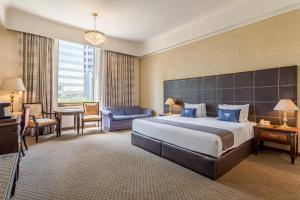 Un pat sau paturi într-o cameră la Hotel Imperial Reforma