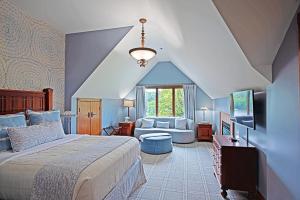 a bedroom with a bed and a living room at Bob Timberlake Inn at Chetola Resort in Blowing Rock
