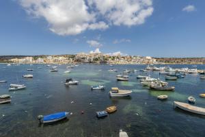 Une bande de bateaux assis dans l'eau dans l'établissement Adorable Seaview apt at St Paul's Bay, à San Pawl il-Baħar