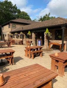 a group of picnic tables in front of a building at Ramblers Rest in Meopham