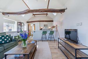 a living room with a couch and a table at Dairy Barn by Bloom Stays in Groombridge