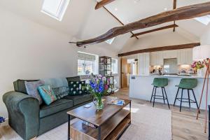 a living room with a couch and a table at Dairy Barn by Bloom Stays in Groombridge