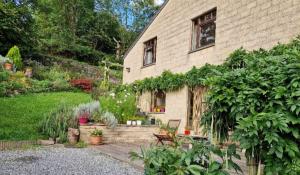 a house with a garden in front of it at Bali in Aywaille