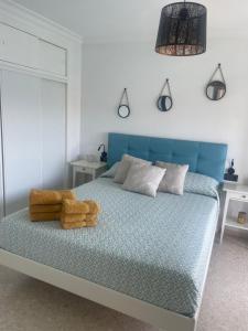 a bedroom with a blue bed with a stuffed animal on it at VISTAS ROCA MAR in La Línea de la Concepción