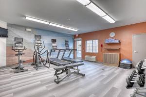 a gym with two treadmills and two exercise bikes at Candlewood Suites Milwaukee Airport - Oak Creek, an IHG Hotel in Greendale