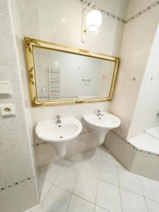 a bathroom with two sinks and a large mirror at Center of Prague Apartment 369 in Prague
