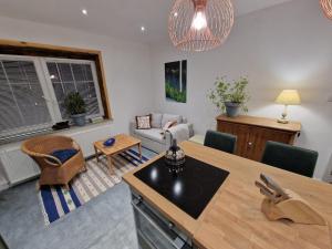 a kitchen and living room with a couch and a table at Apartment Emilia in Świdnica +27 photos