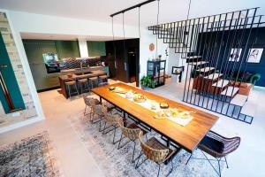 a dining room with a wooden table and chairs at Magdala Lodge - wellness oasis in Donja Pušća