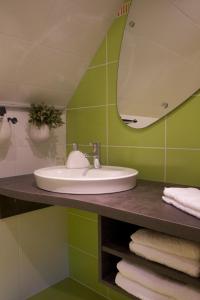 a bathroom with a sink and a mirror at Le Grenier Des Arômes Au Domaine Wittmann in Mittelbergheim +32 photos