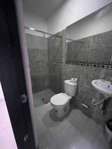 a bathroom with a toilet and a sink at Hotel Boutique Deluxe in Santa Marta