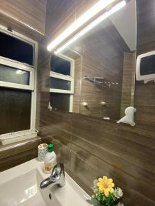 a bathroom with a sink and a mirror at La casa de Halima in Sidi Ifni