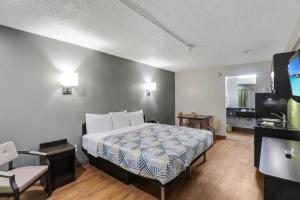 a hotel room with a bed and a television at Studio 6-Bryan, TX - University Area in Bryan