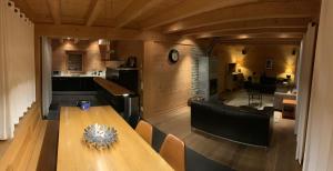 a dining room with a table and a kitchen at Chalet Courage in Champéry