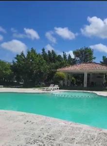 a house with a swimming pool next to a beach at Serena star3 in Punta Cana