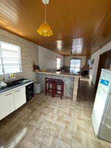 a kitchen with a refrigerator and a counter top at Casa VIRAMAR in Barra del Chuy