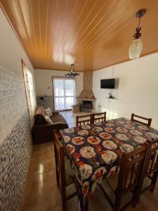a dining room with a table and a room with a couch at Casa VIRAMAR in Barra del Chuy