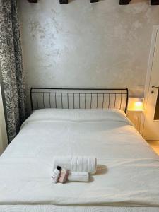 a bed with two towels and two products on it at Ca'Rosa in Venice