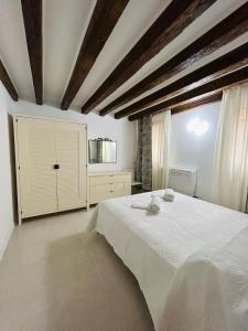 a bedroom with a large white bed and a window at Ca'Rosa in Venice
