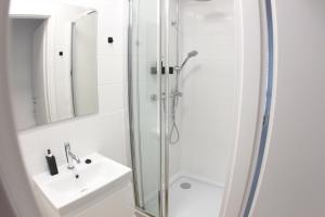 a bathroom with a shower and a sink at Komfi Dom 4 in Rzeszów