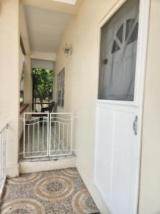 a hallway with a white door and a tile floor at Sun Lover's Apartments in The Lime