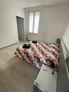 a bedroom with a bed with a red comforter at Seveso appartamento nuovo tra Milano, Monza e Como in Seveso