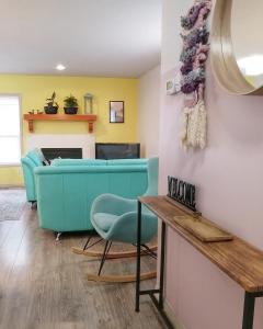 a living room with a blue couch and a table at Bright 3 bed 3 bath House in Radium Hot Springs in Radium Hot Springs