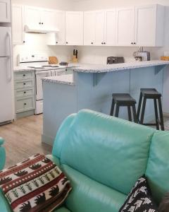 a living room with a couch and a kitchen at Bright 3 bed 3 bath House in Radium Hot Springs in Radium Hot Springs