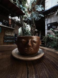 a planter with a face on it sitting on a table at La Punta in Brisas de Zicatela