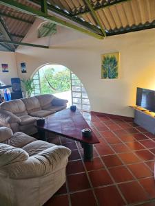 a living room with a couch and a coffee table at Cabaña Mountain Ocean View Minca in Minca