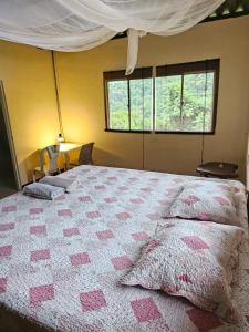 a bedroom with a bed with pink hearts on it at Cabaña Mountain Ocean View Minca in Minca