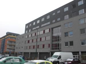a large building with cars parked in front of it at Terrace Rooms Rental in Bratislava