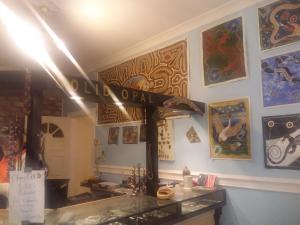 uma loja com um cartaz na parede com pinturas em Opal Art House em Coober Pedy