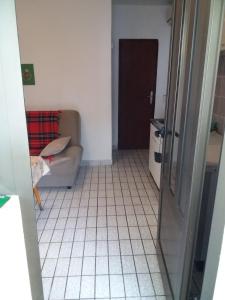 a living room with a couch and a tiled floor at Apartman - Sutomore in Sutomore